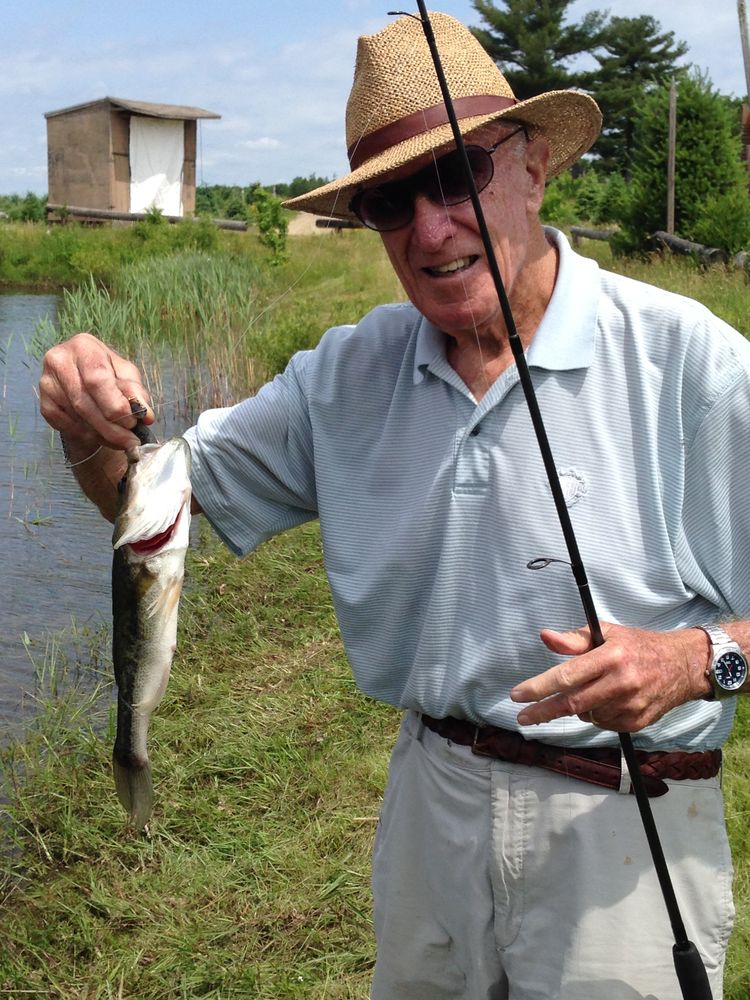 Showing off a fish caught at the farm pond